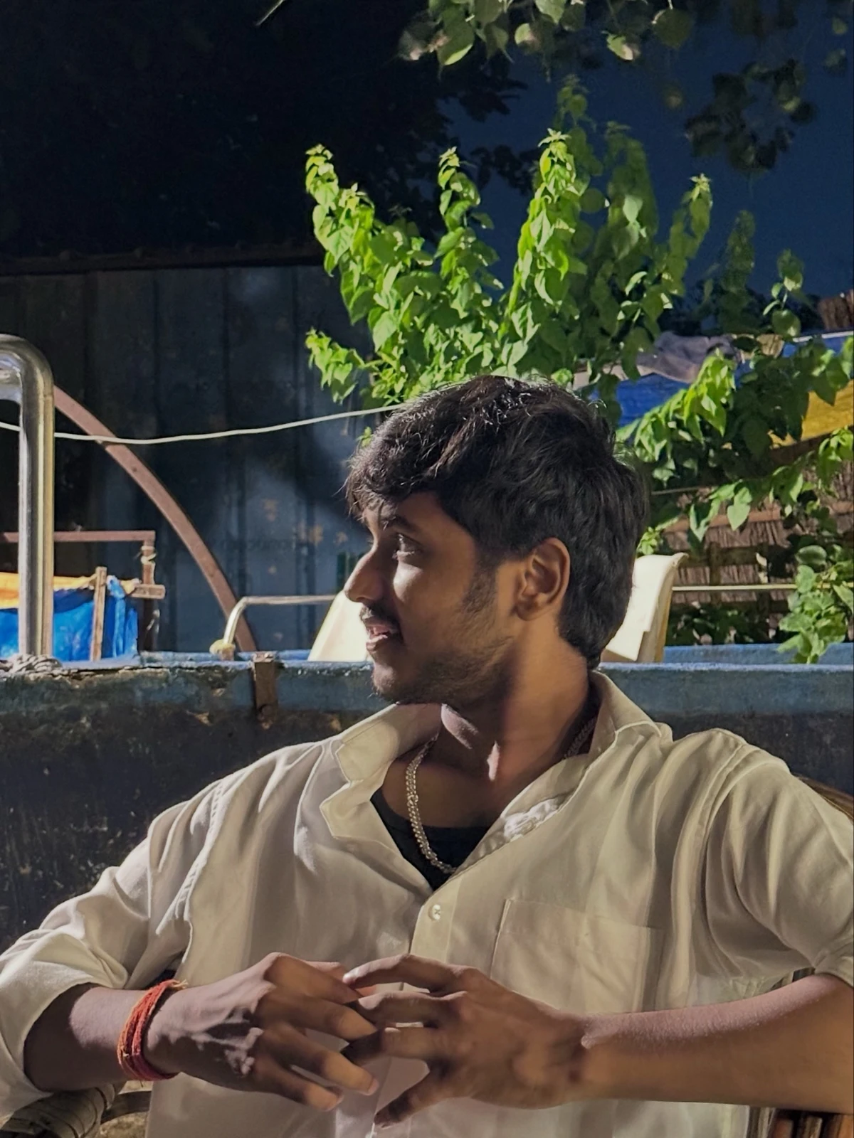 Harsh in a cream shirt in an evening setting