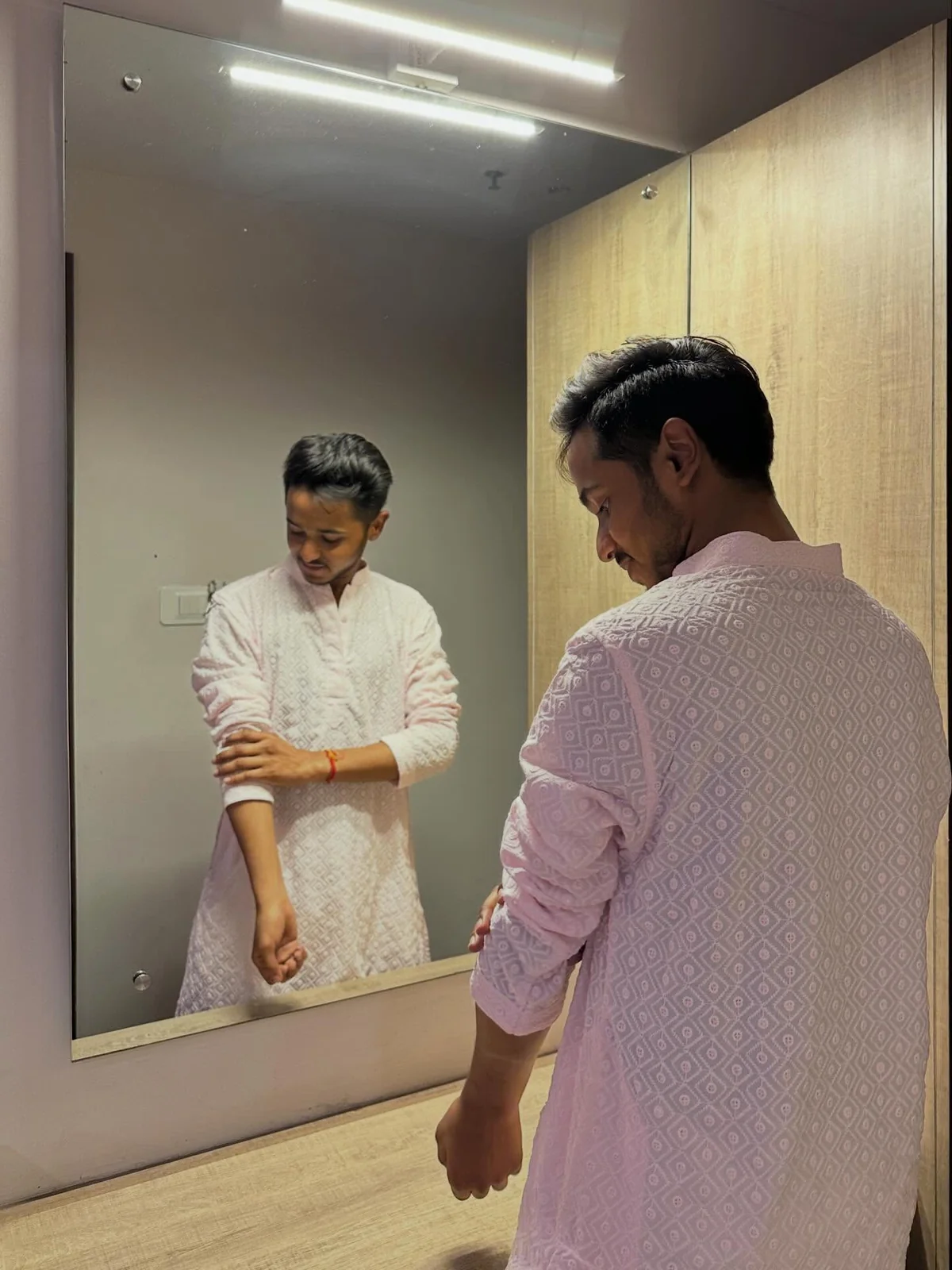 Harsh wearing a pale pink kurta