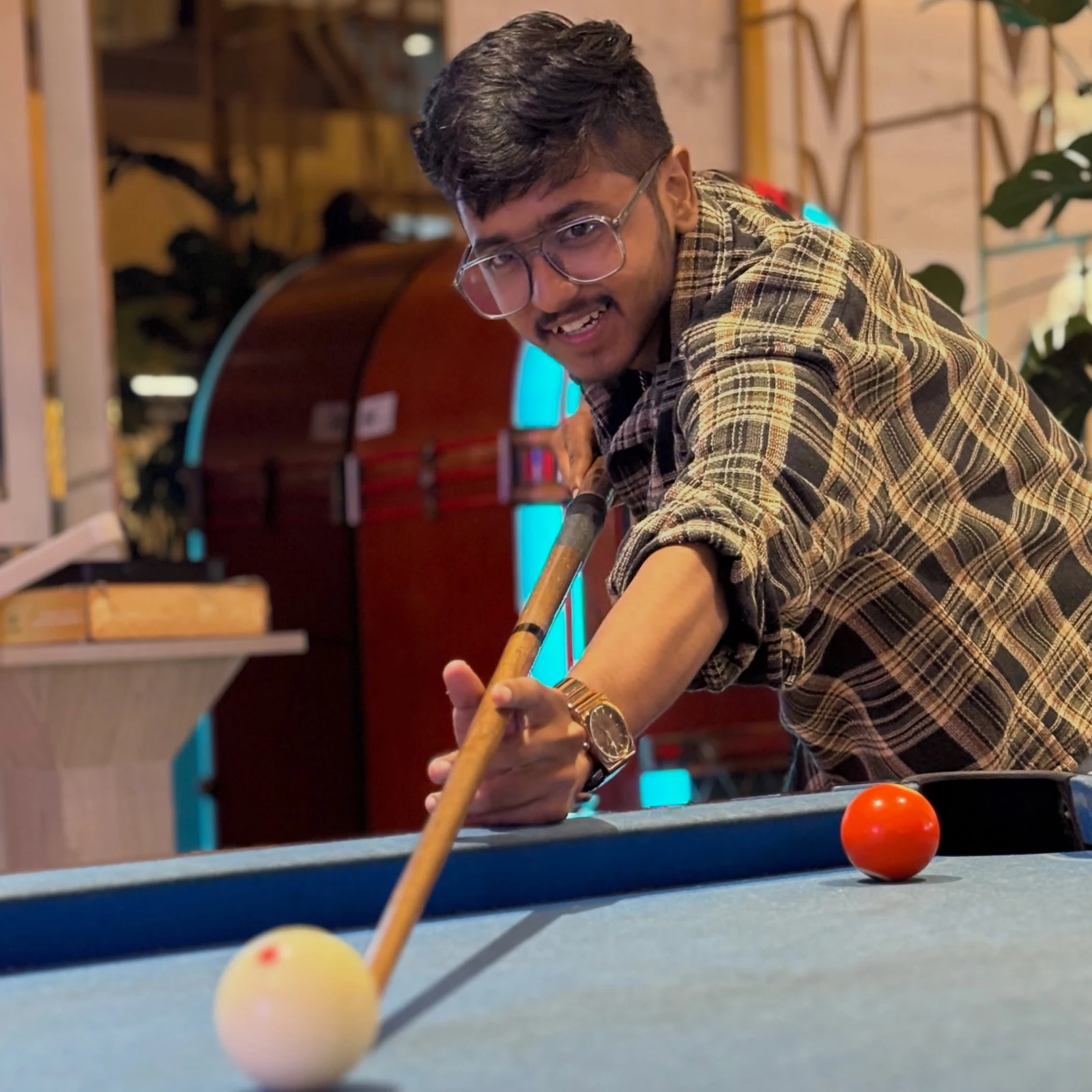 Harsh playing pool — a moment away from work