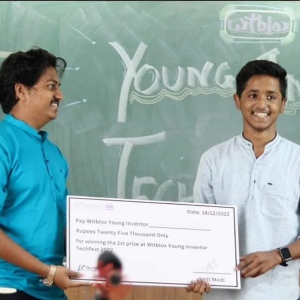Harsh receiving the Witblox Young Inventor first prize at Techfest, IIT Bombay; the cheque records twenty-five thousand rupees and 18 December 2022